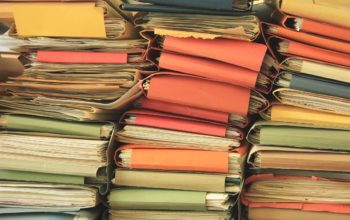 Stacked office files: pile of paperwork in an office